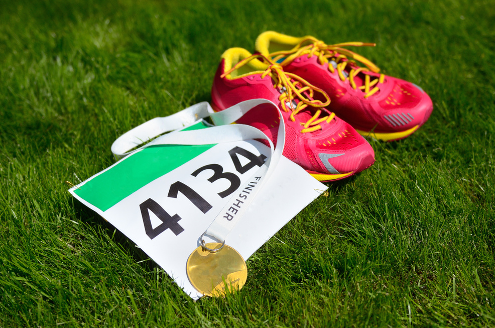 Running shoes,  marathon race bib (number) and finisher medal