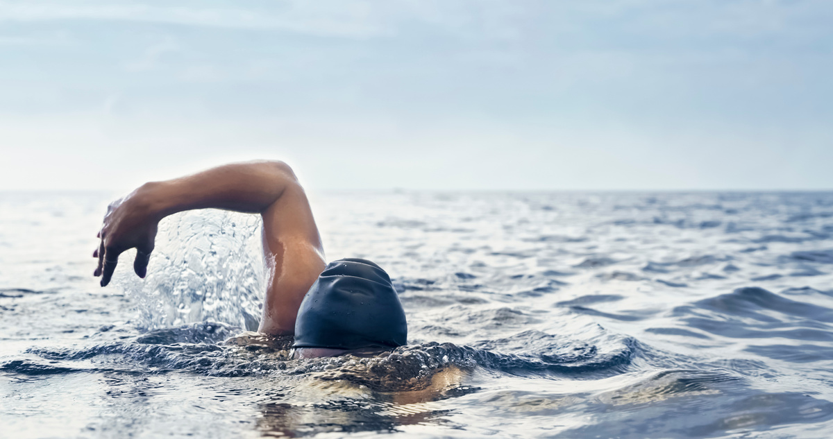 Open water swimmer swimming in sea