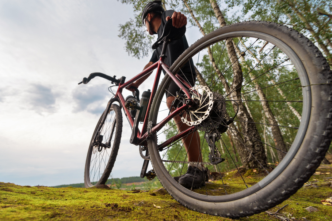 Cyclist with a gravel bike enjoying the beautiful scenery. Low angle view.