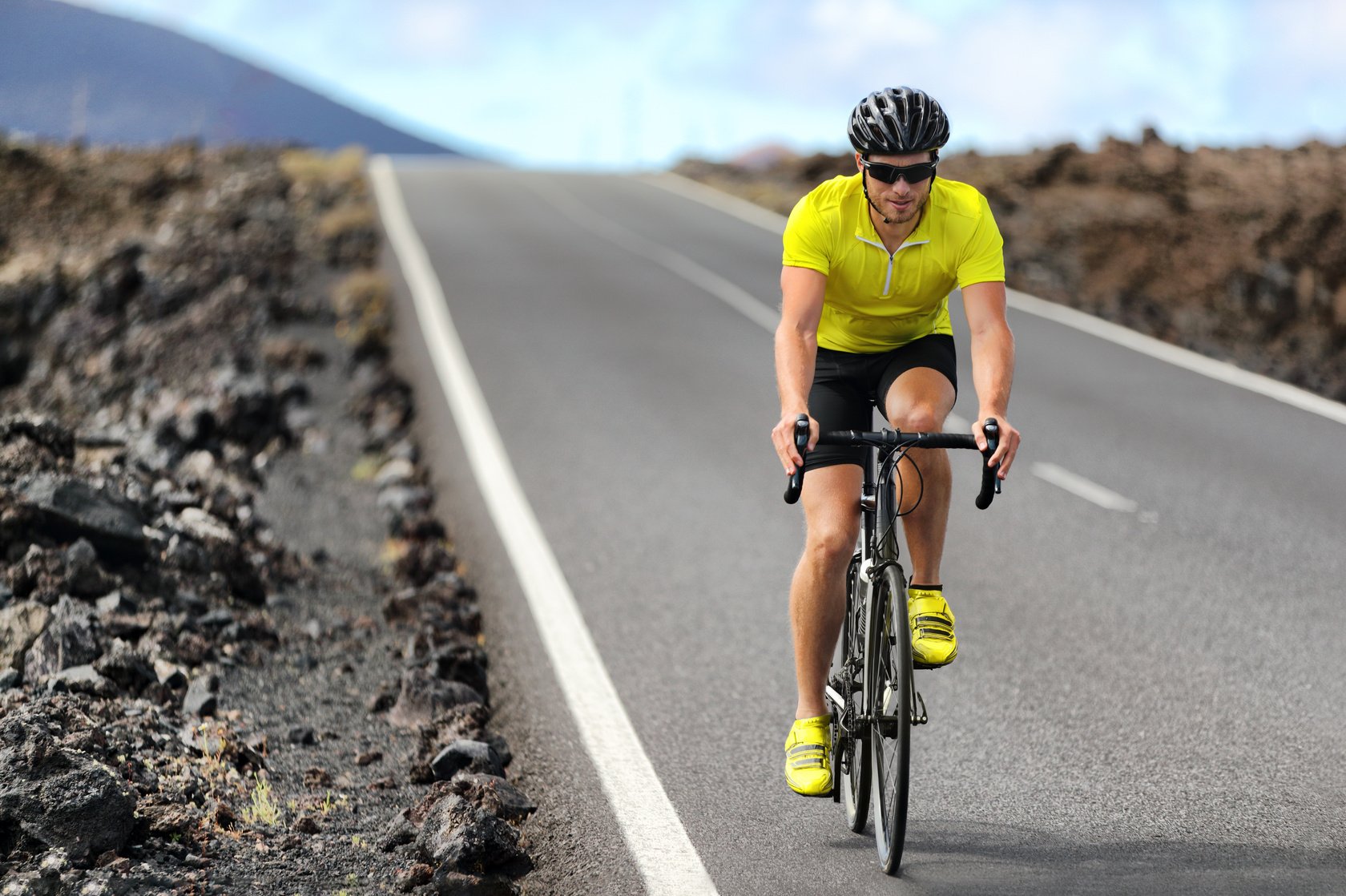 Road Bike Cyclist Man Cycling. Biking Sport Fitness Athlete Biking on Road Bike. Active Healthy Sports Lifestyle Athlete Cycling outside Training for Triathlon.